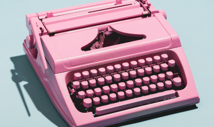 Writing Contest image showing a pink typewriter